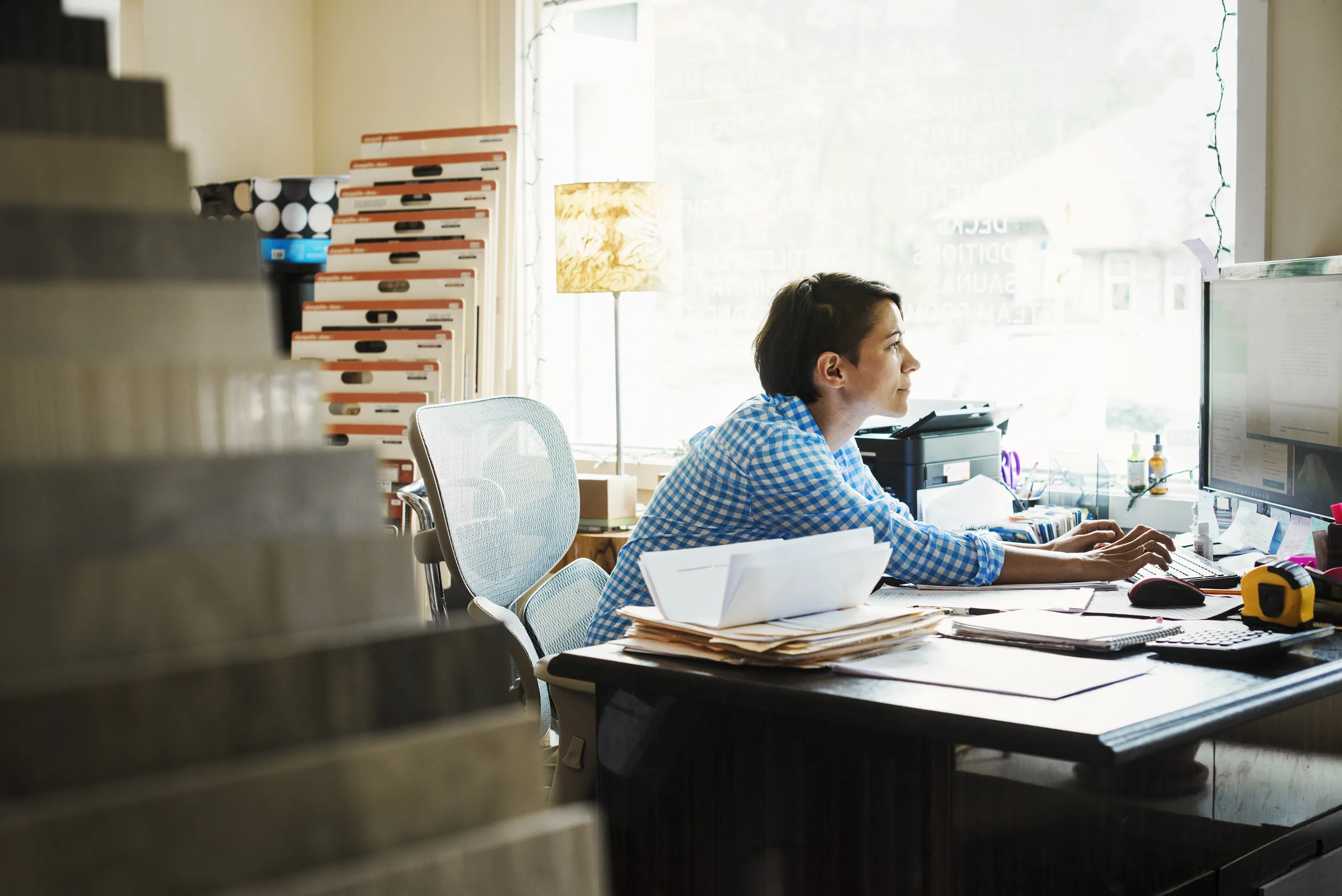 Woman working at her desk in a design studio