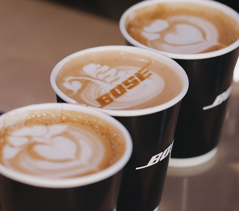 Mobile event barista prints the Bose logo on a latte at a corporate event