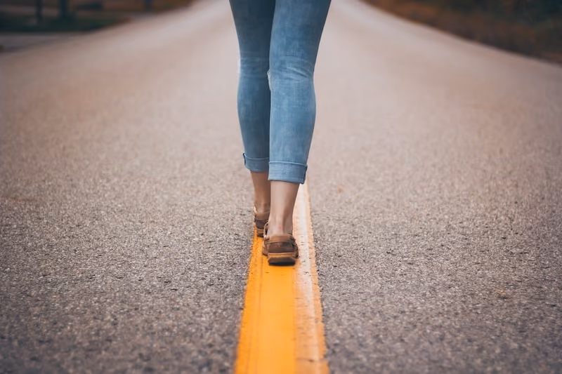 woman walking on road