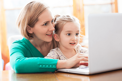 Mother and daughter using their computer