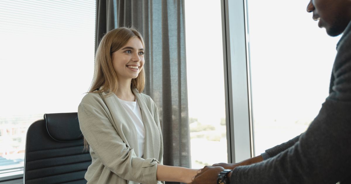 Candidate and recruiter shaking hands after a successful interview