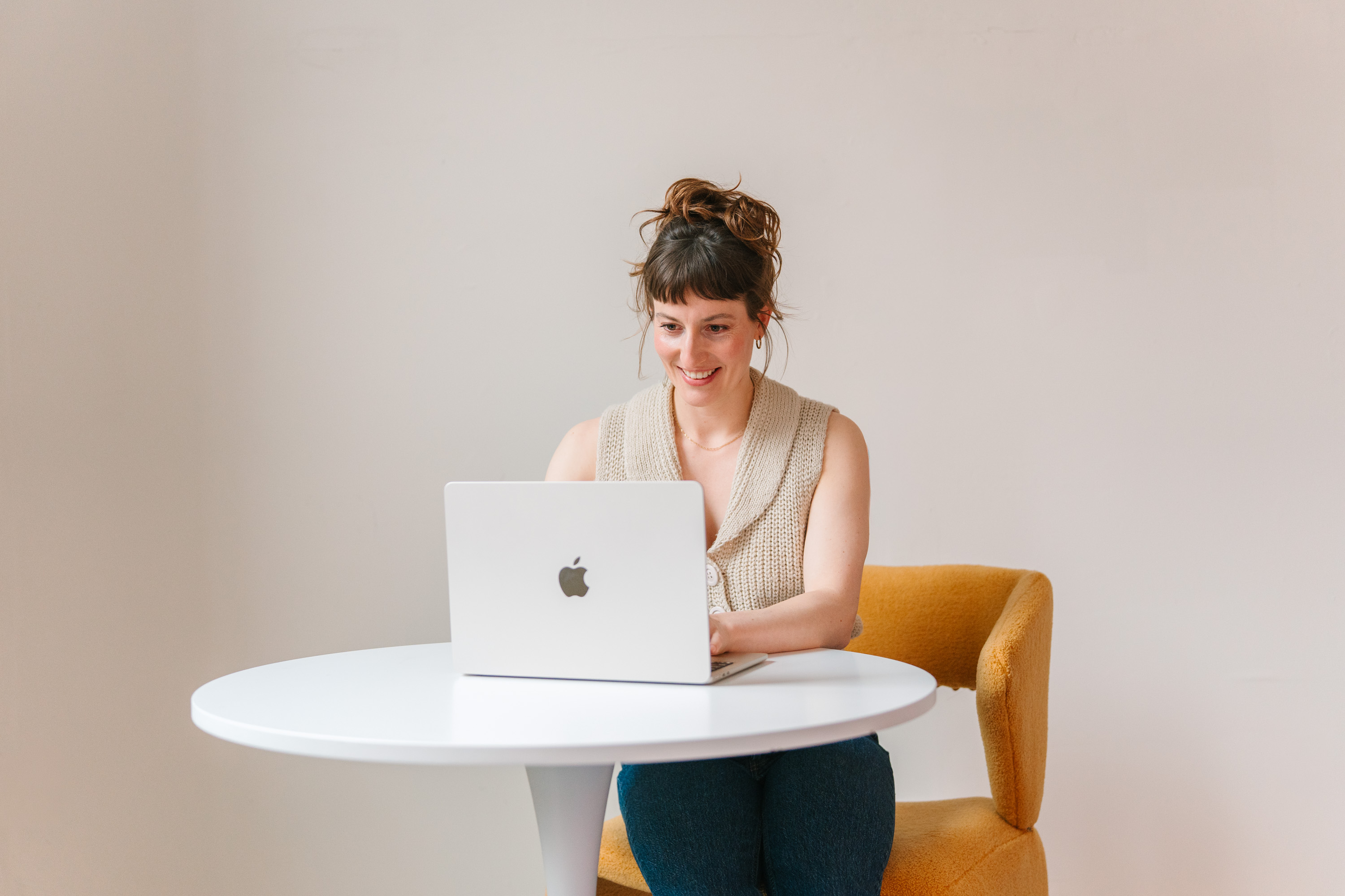 Deanne Vincent working at a laptop at a white table