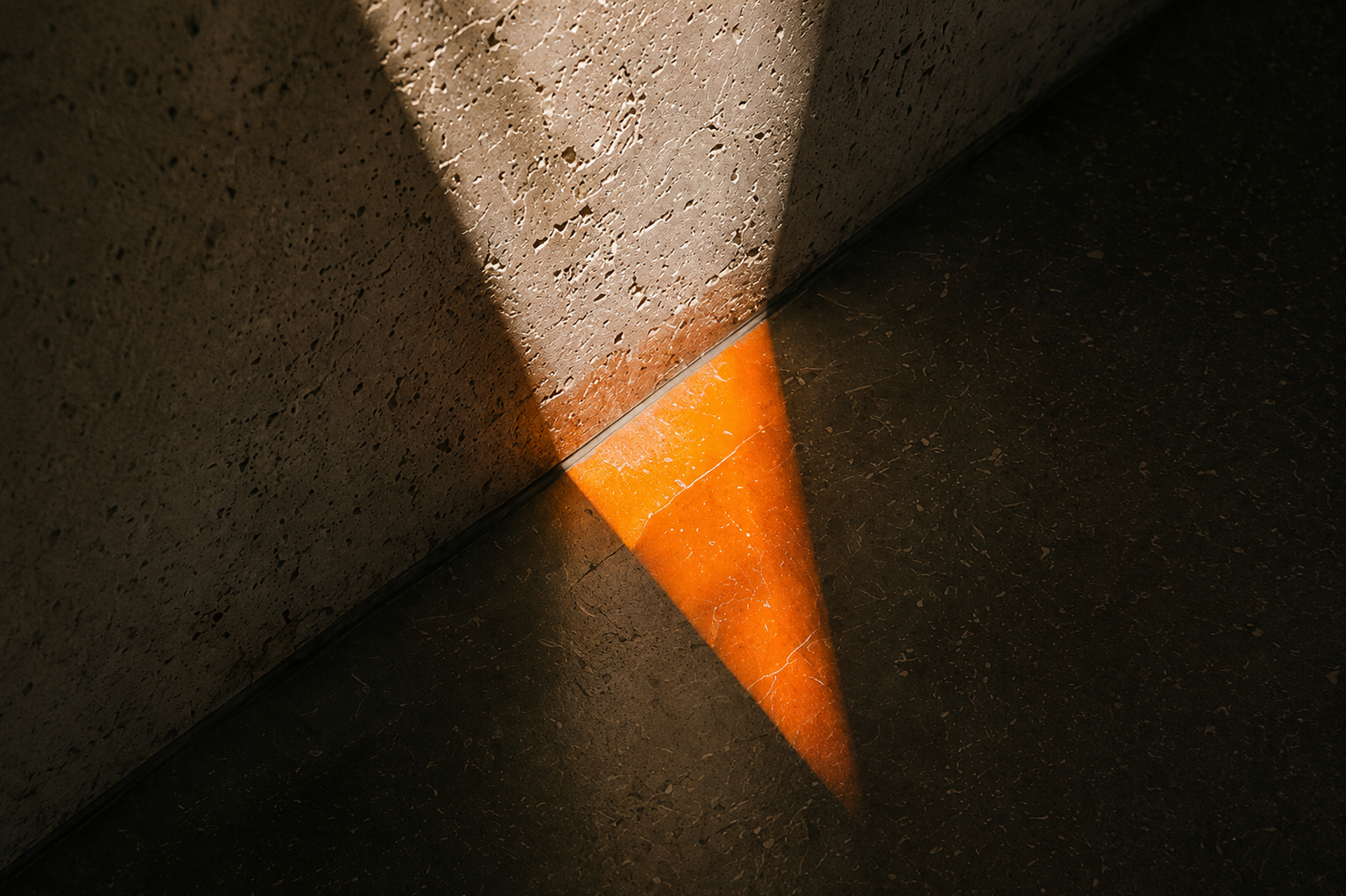 Orange against a concrete wall