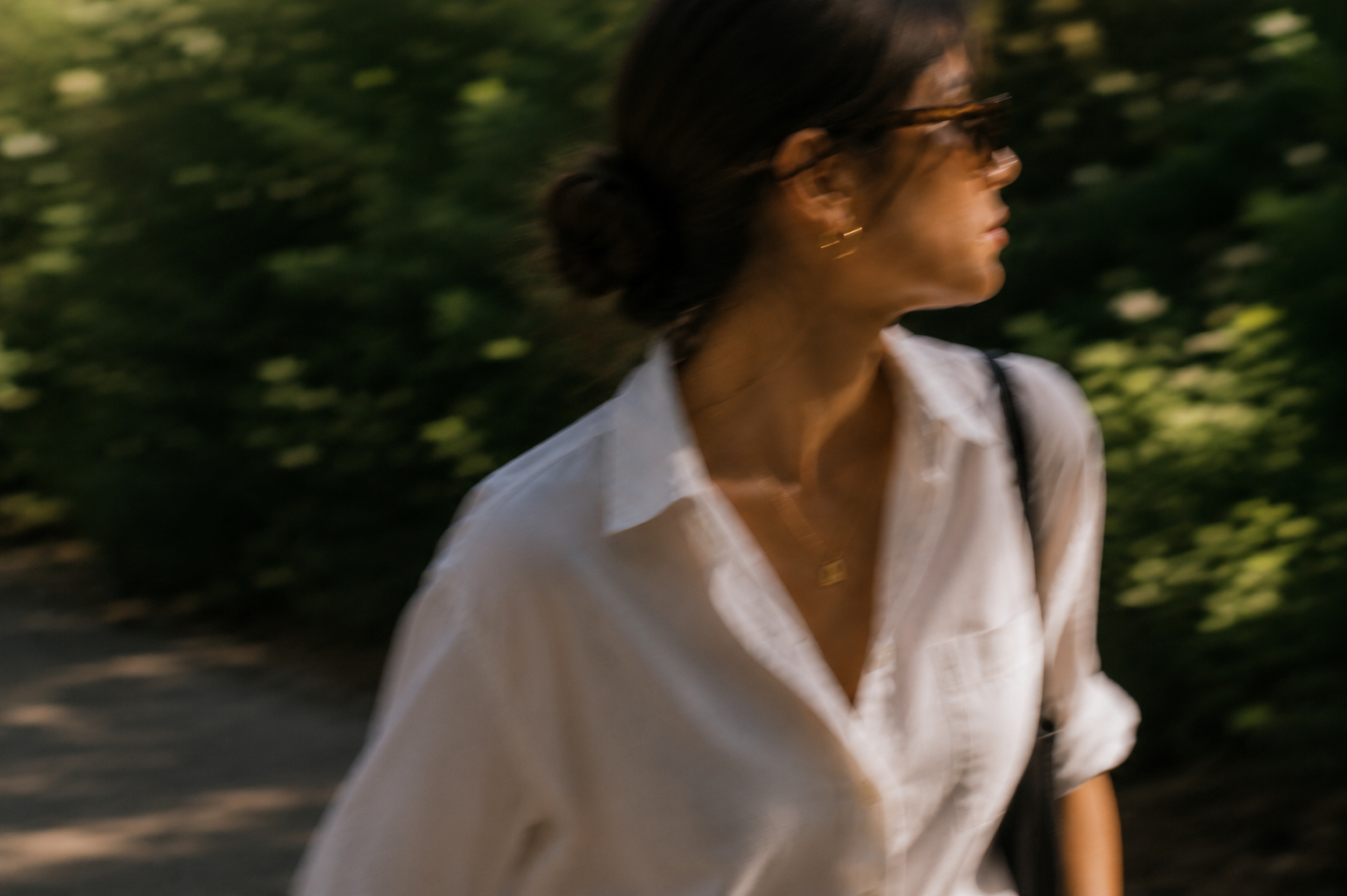 Woman walking through green surroundings