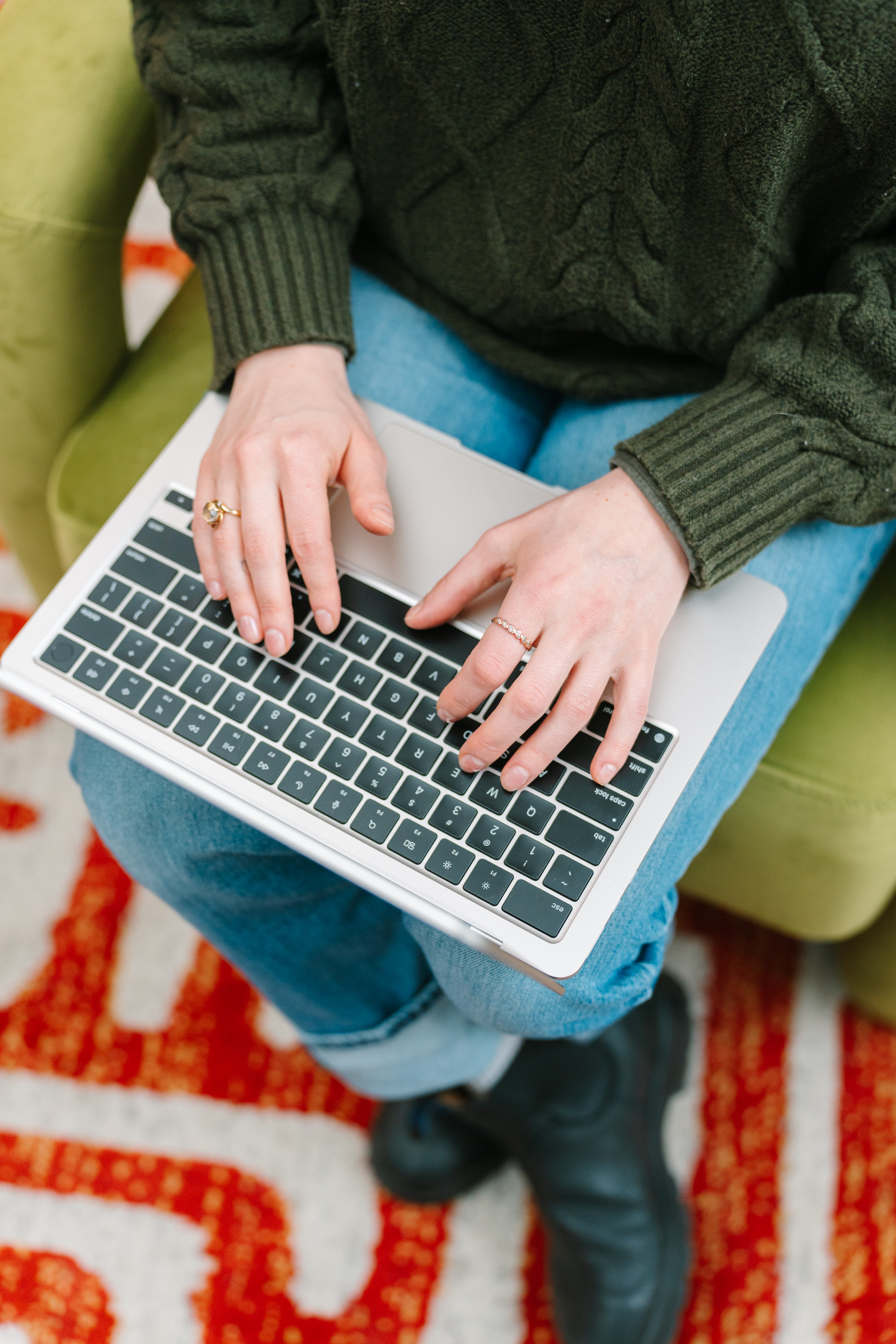 Deanne's hands typing on a laptop