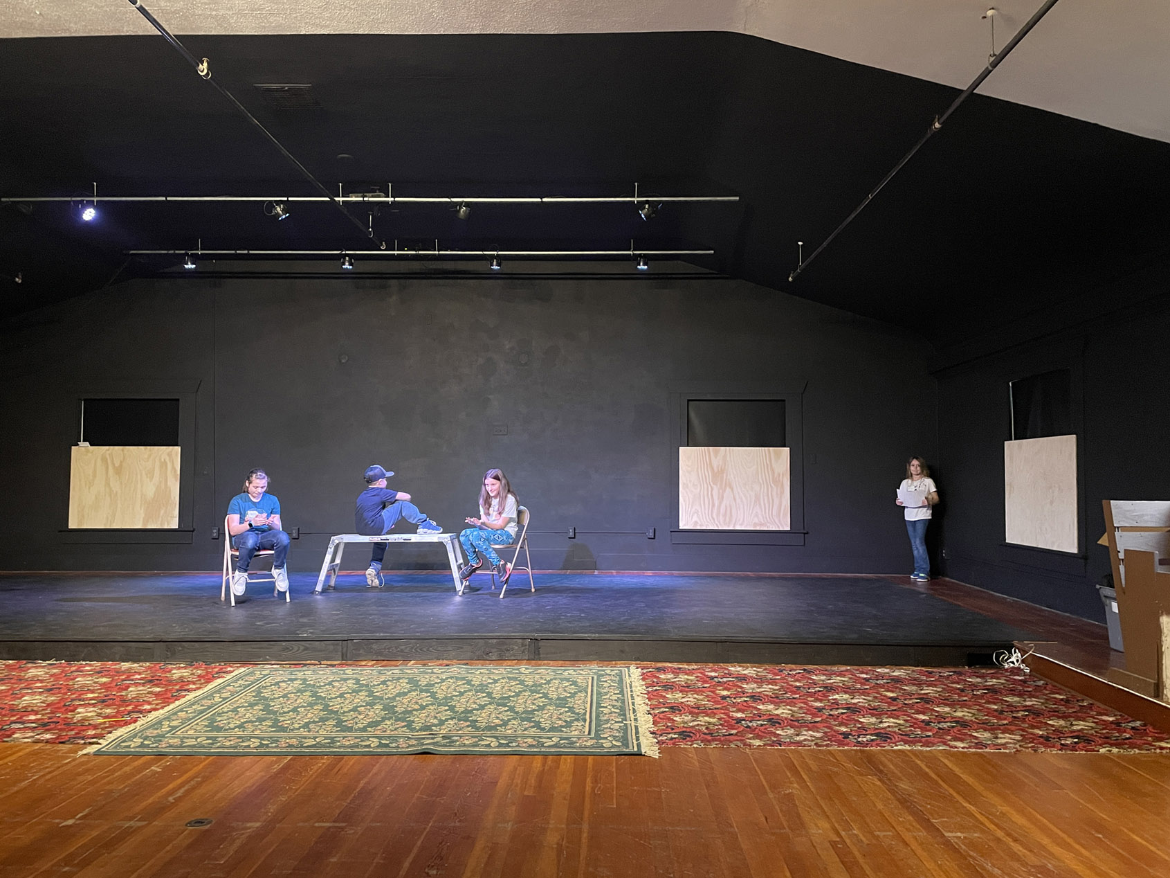 The performance hall set up with chairs for a reading