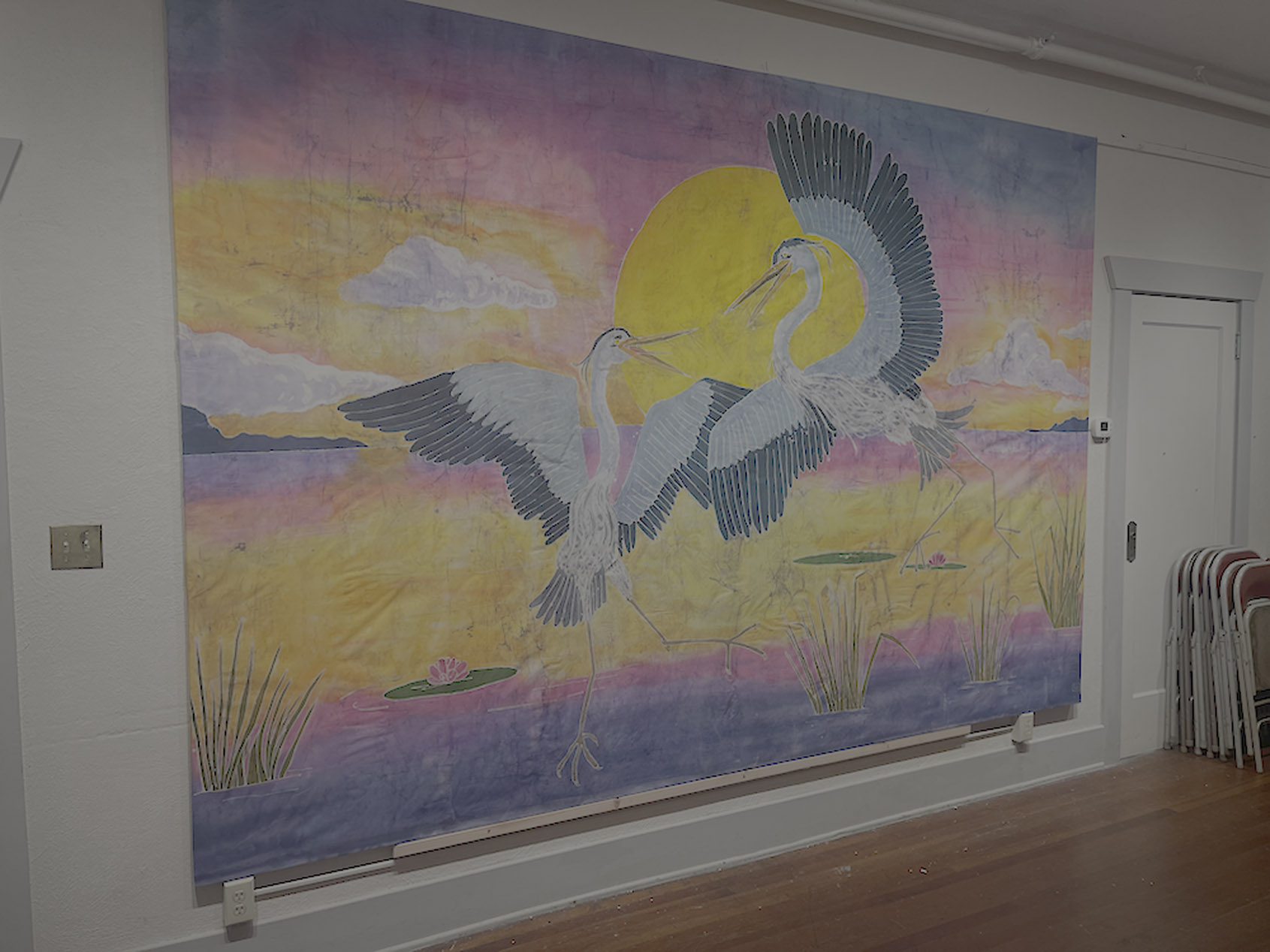 Batik heron mural hanging in the performance hall