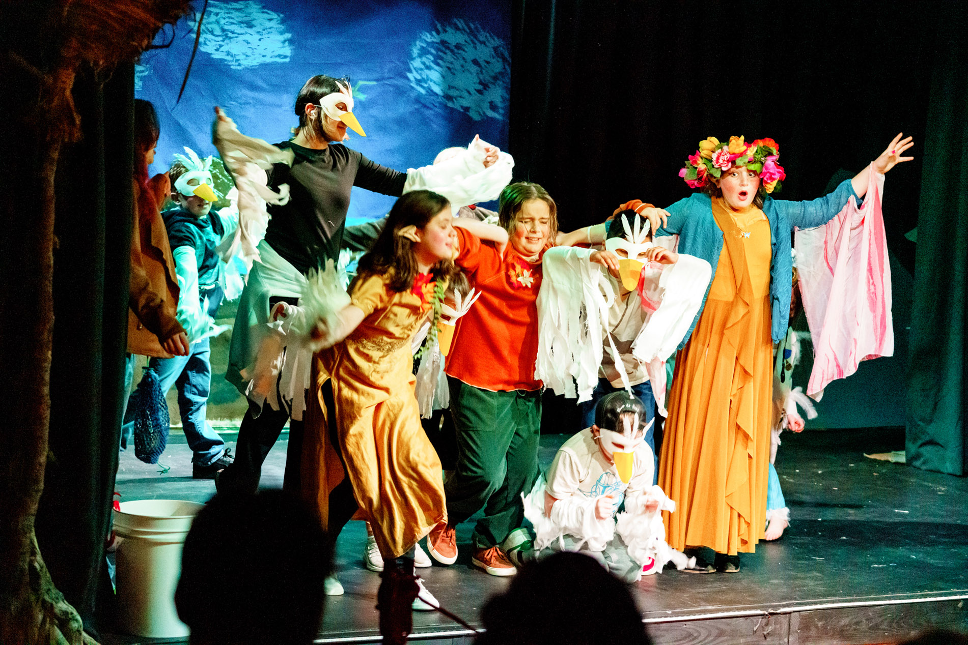 Young performers in handmade bird masks on the BCAC stage