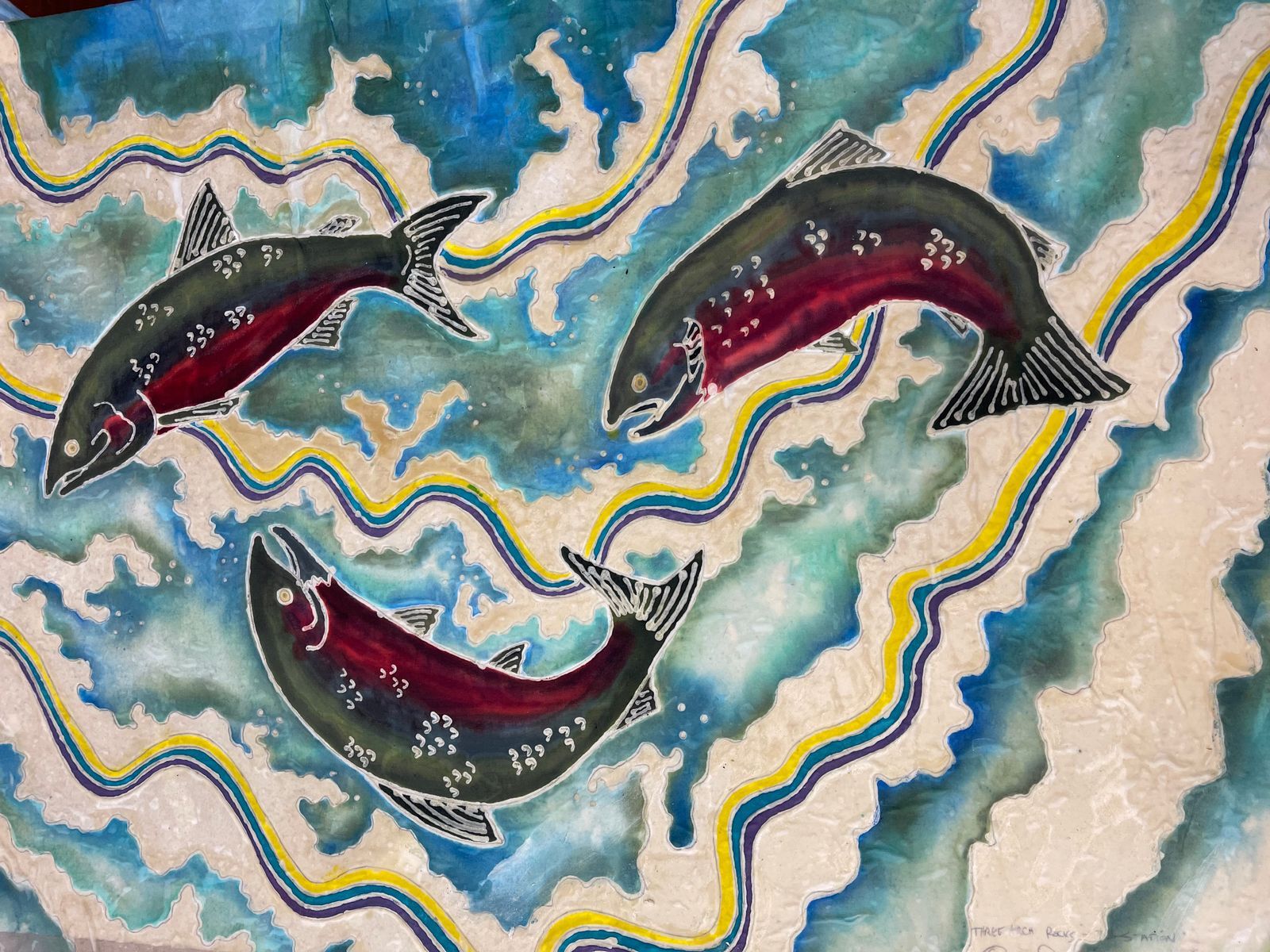 Batik salmon on fabric, made in a BCAC textiles workshop