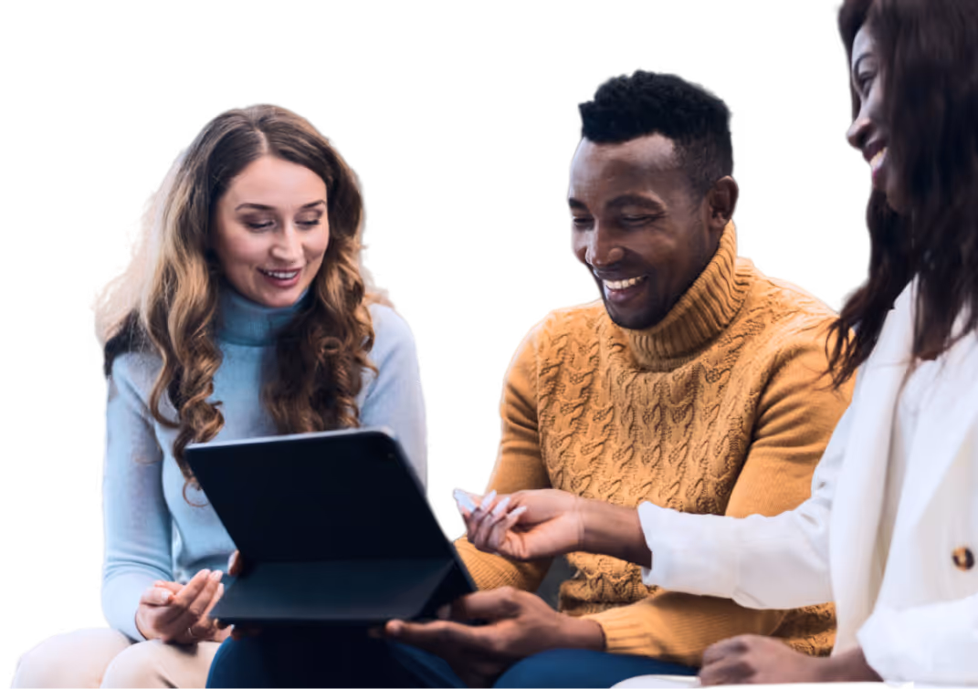 Three people smiling and looking at a tablet together in a casual meeting or collaboration.