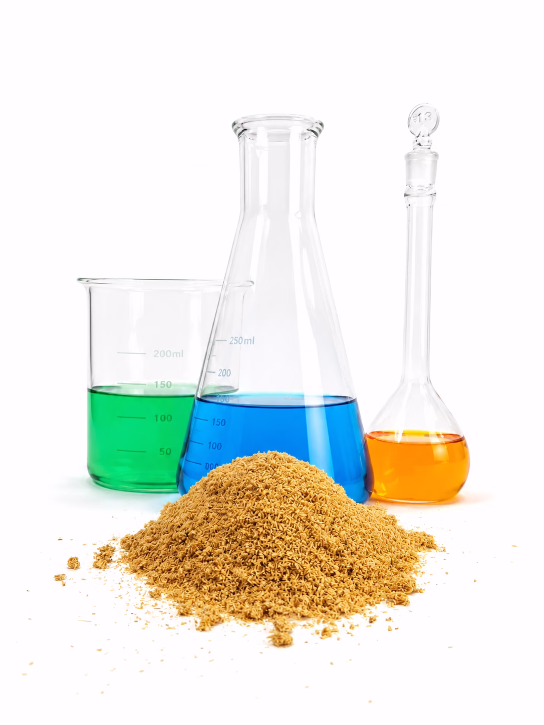 A pile of brown powder in front of three laboratory glassware containing green, blue, and orange liquids, on a white background.