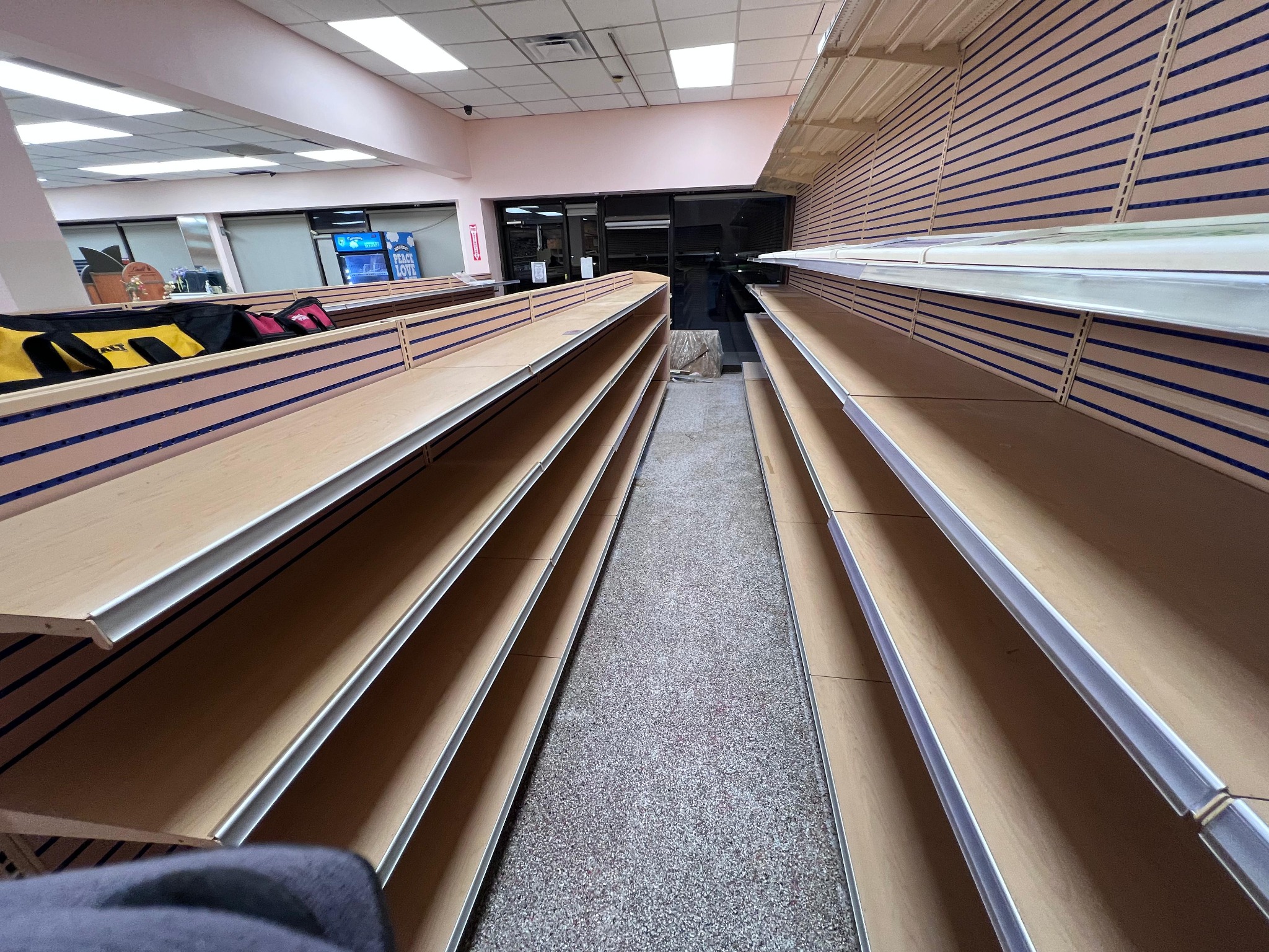 Wood-effect slatwall gondolas with metal shelves at La Rose Bakery