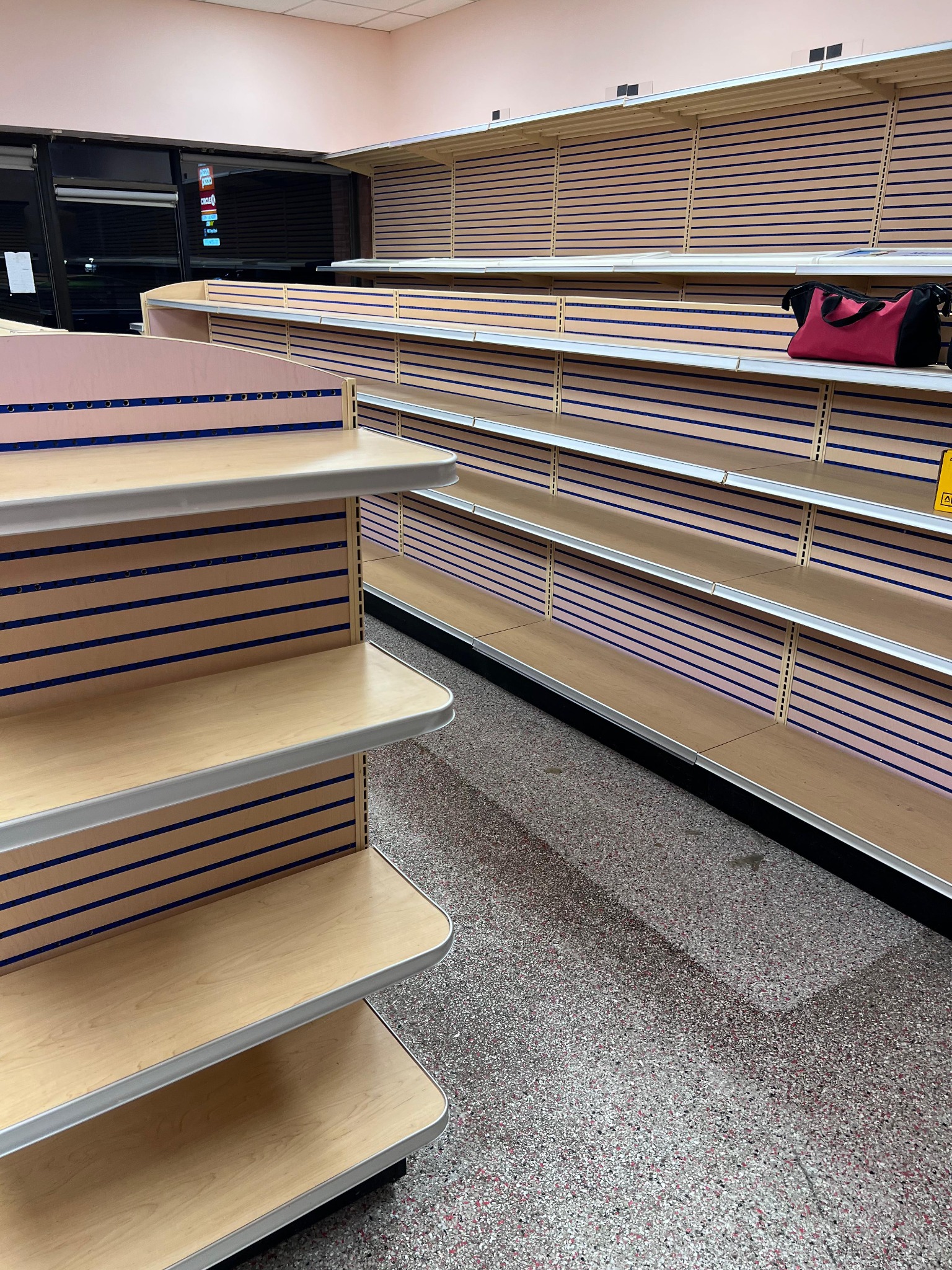 Wood-effect slatwall shelving and a rounded end display installed at La Rose Bakery