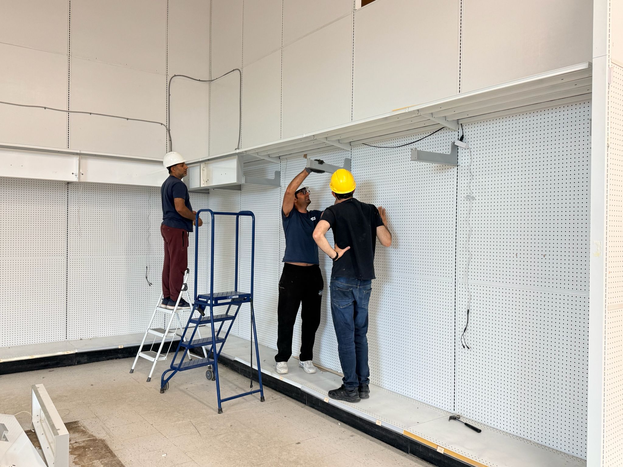 Crew dismantling wall shelving at the former Toys R Us store in Sudbury