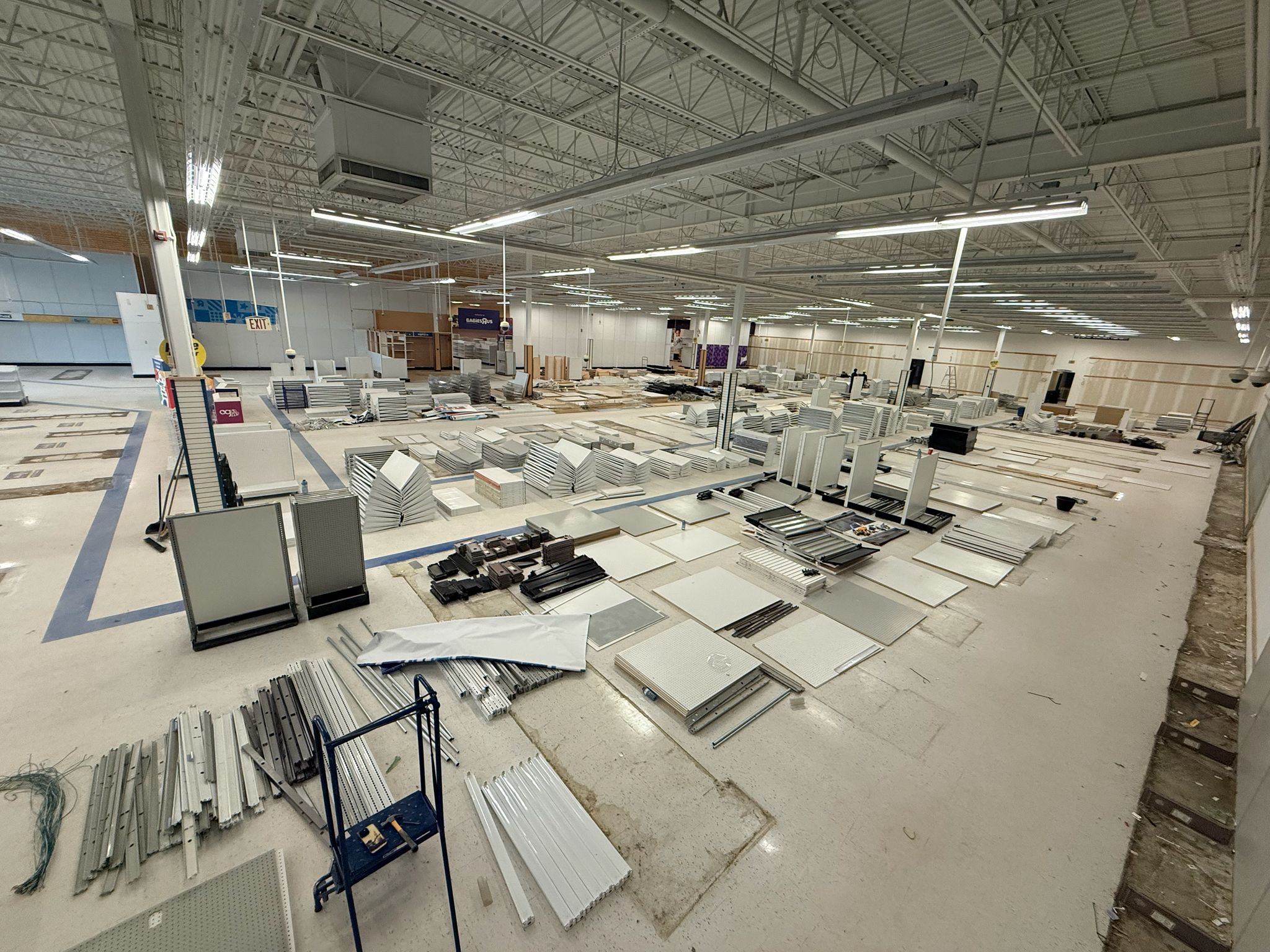 Dismantled shelving panels and supports sorted across the Sudbury store