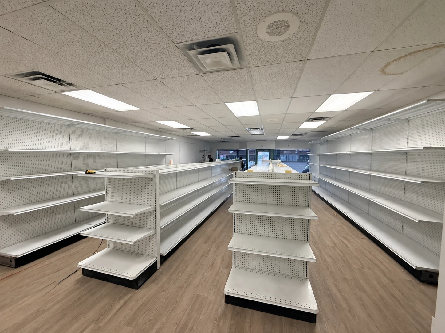 Completed Kitchener, Ontario store with white gondola aisles, end caps and wall shelving