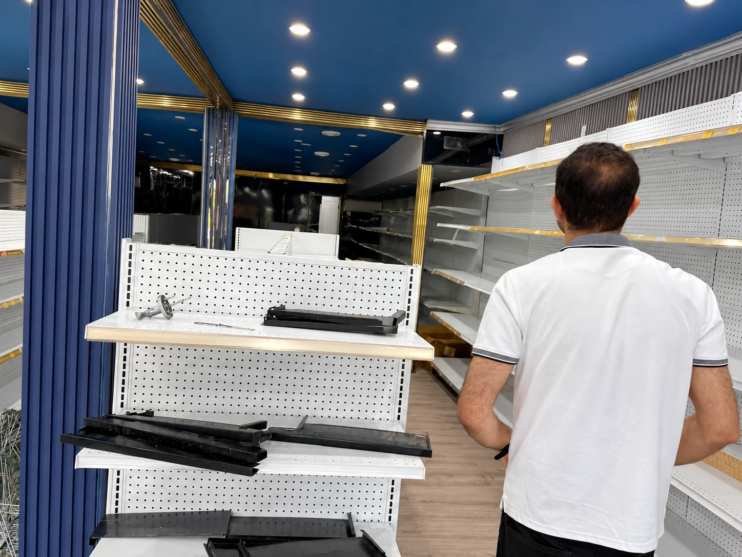 An installer working beside a gondola end display.