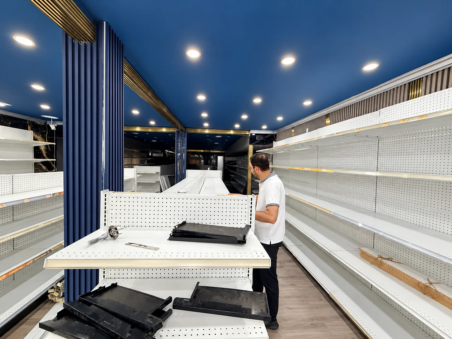 A wider view of the team working within the shelving layout.