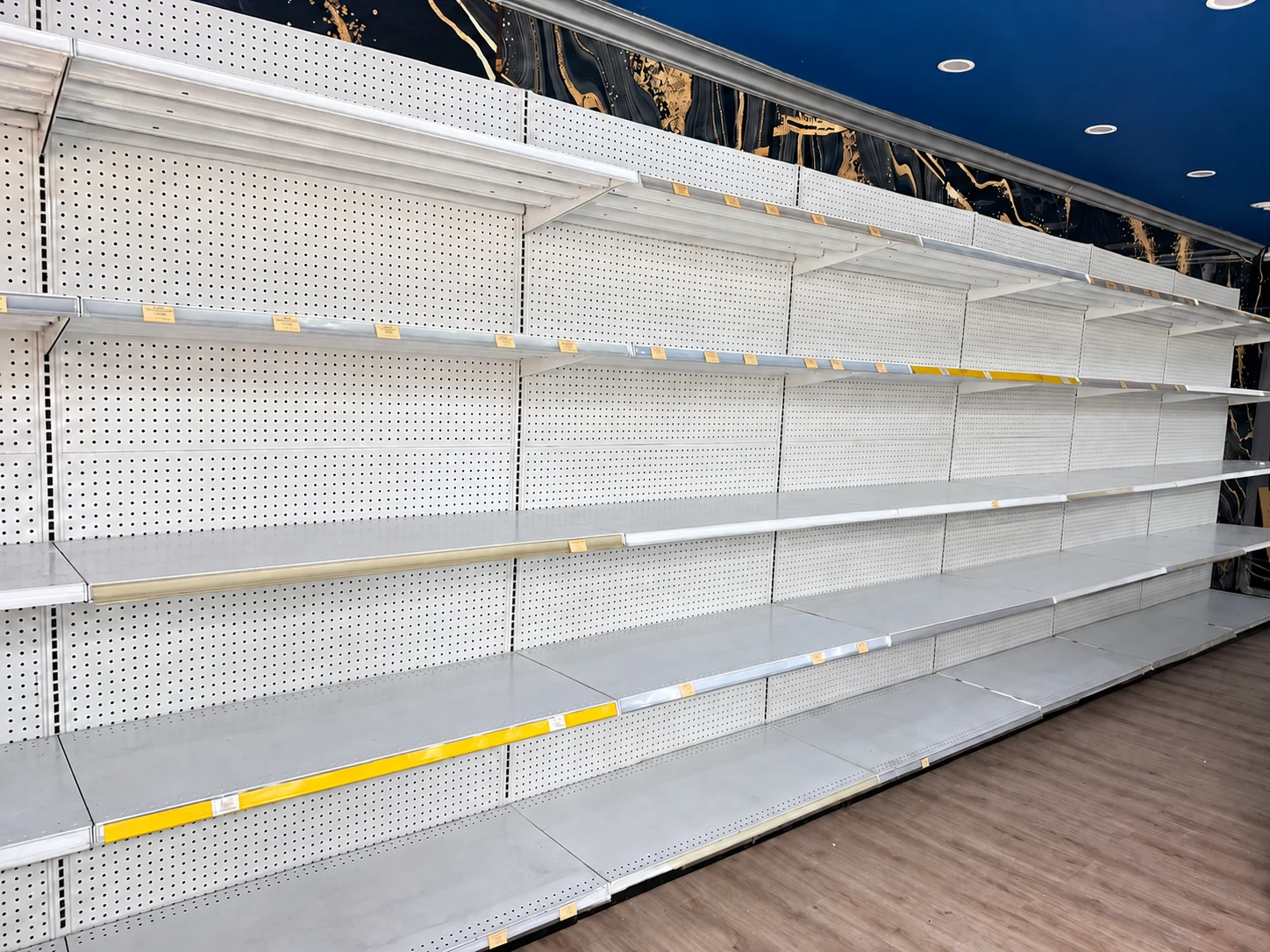 Wall shelving along the store perimeter.