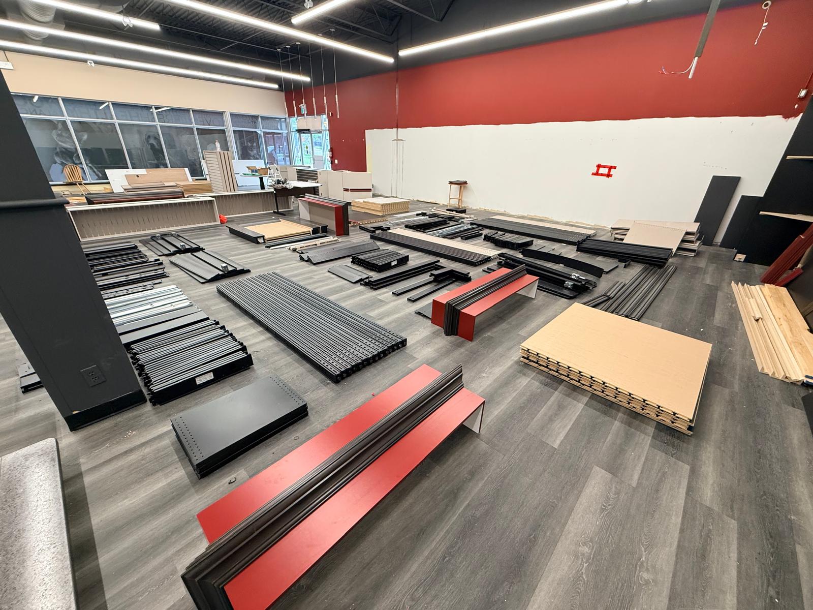 Shelves, panels and red trim laid out during dismantling.