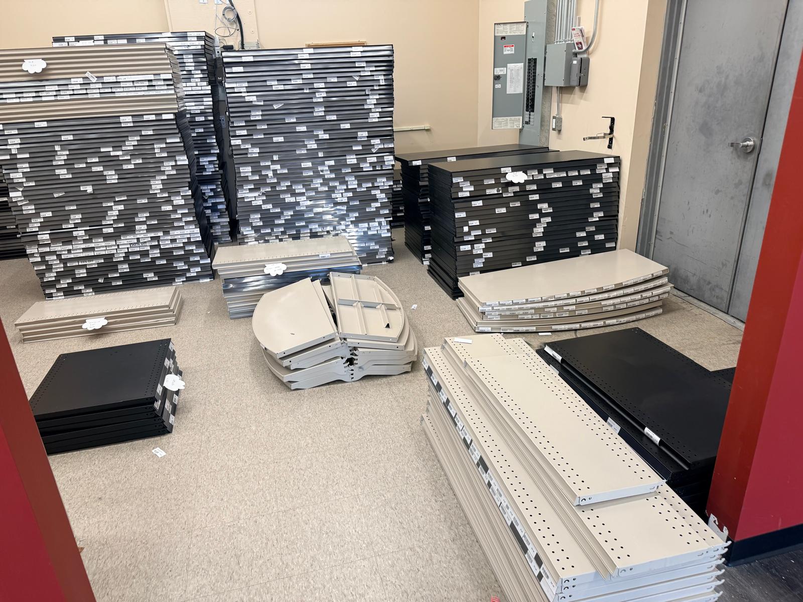 Fixture panels and shelving components stacked for handling.