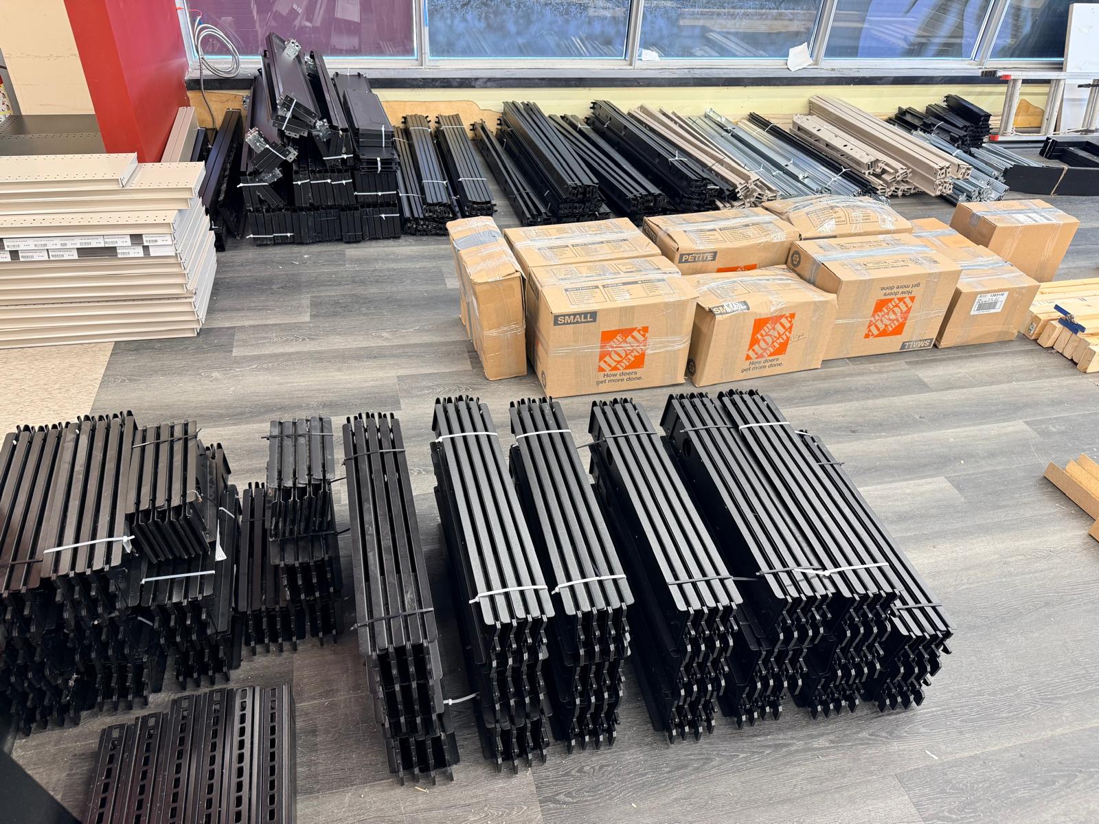 Uprights, brackets and boxed components sorted across the floor.