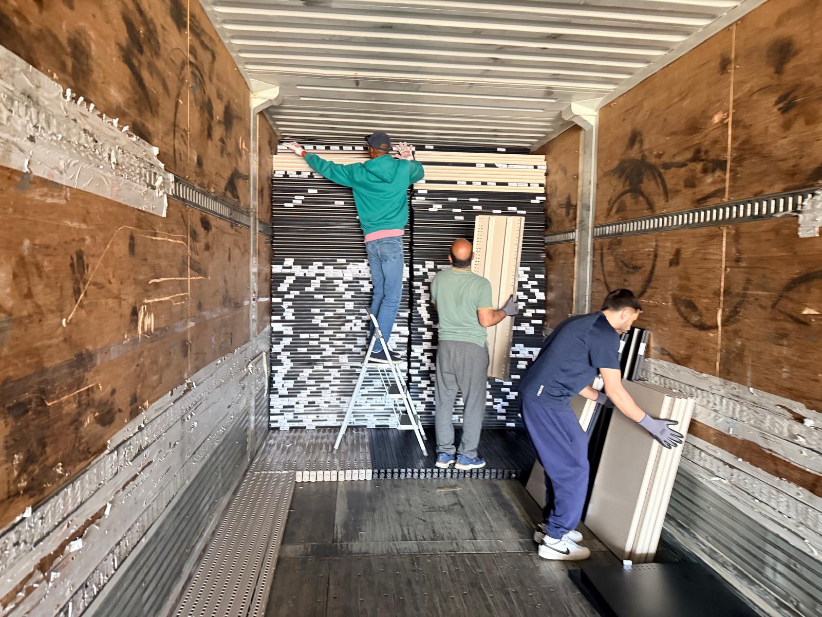 Loading the dismantled shelving into the truck.
