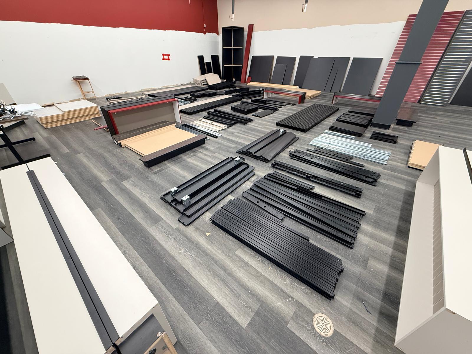 Long rails, panels and shelving pieces separated after dismantling.
