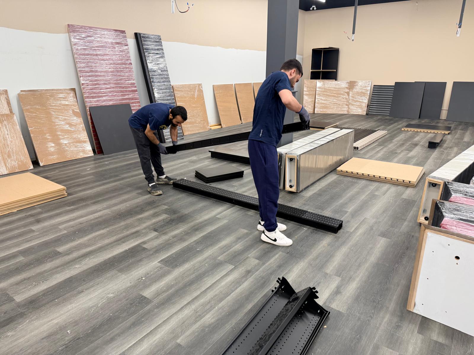 The team taking apart a freestanding fixture.
