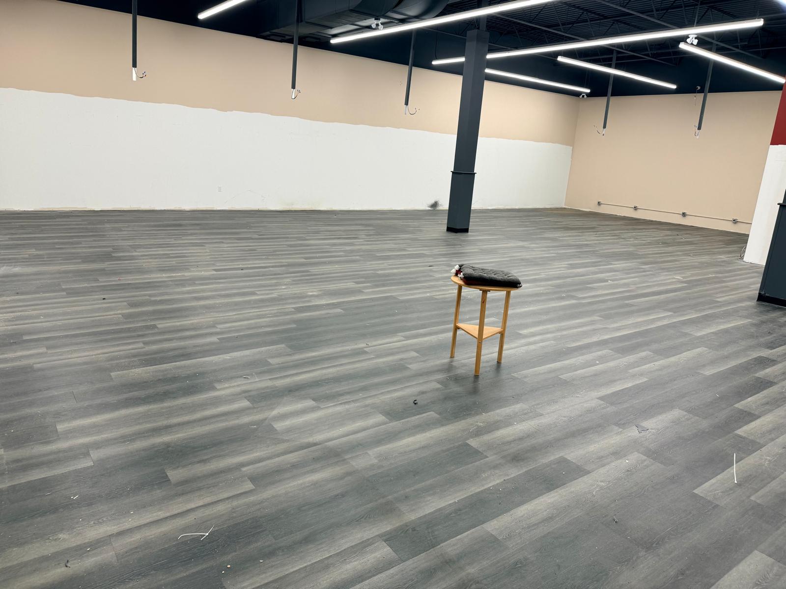 A wide view of the open floor and the remaining building columns.