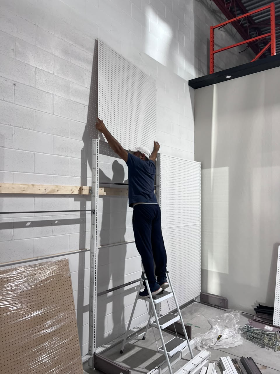 Installing the uprights along the store wall.