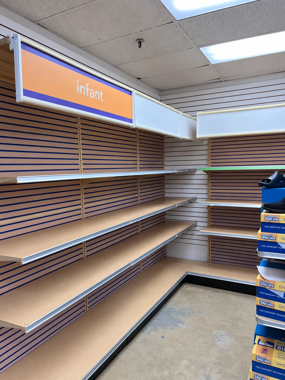 Corner shelving beneath the infant department sign.