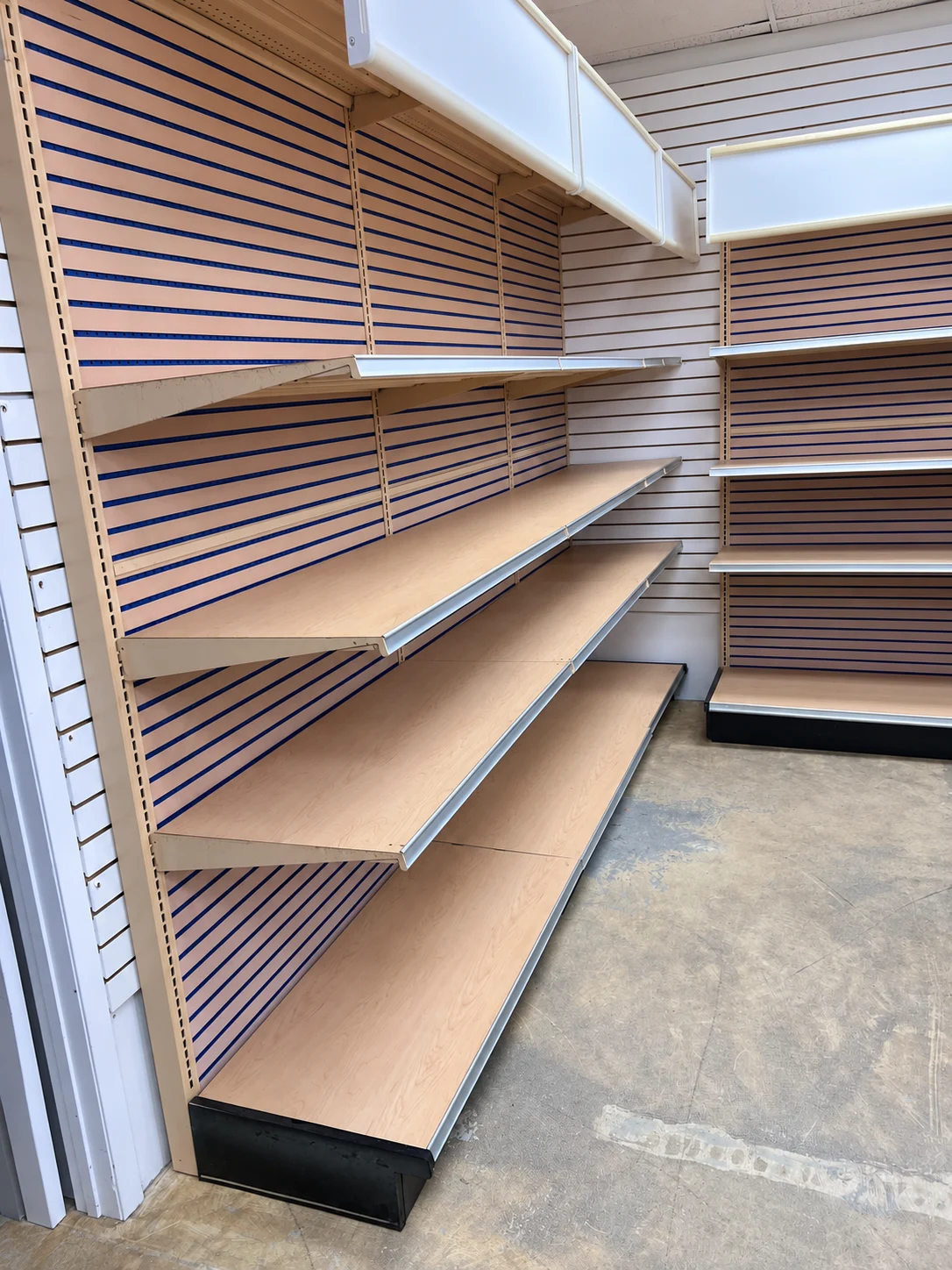 Shelving that follows the corner of the retail space.