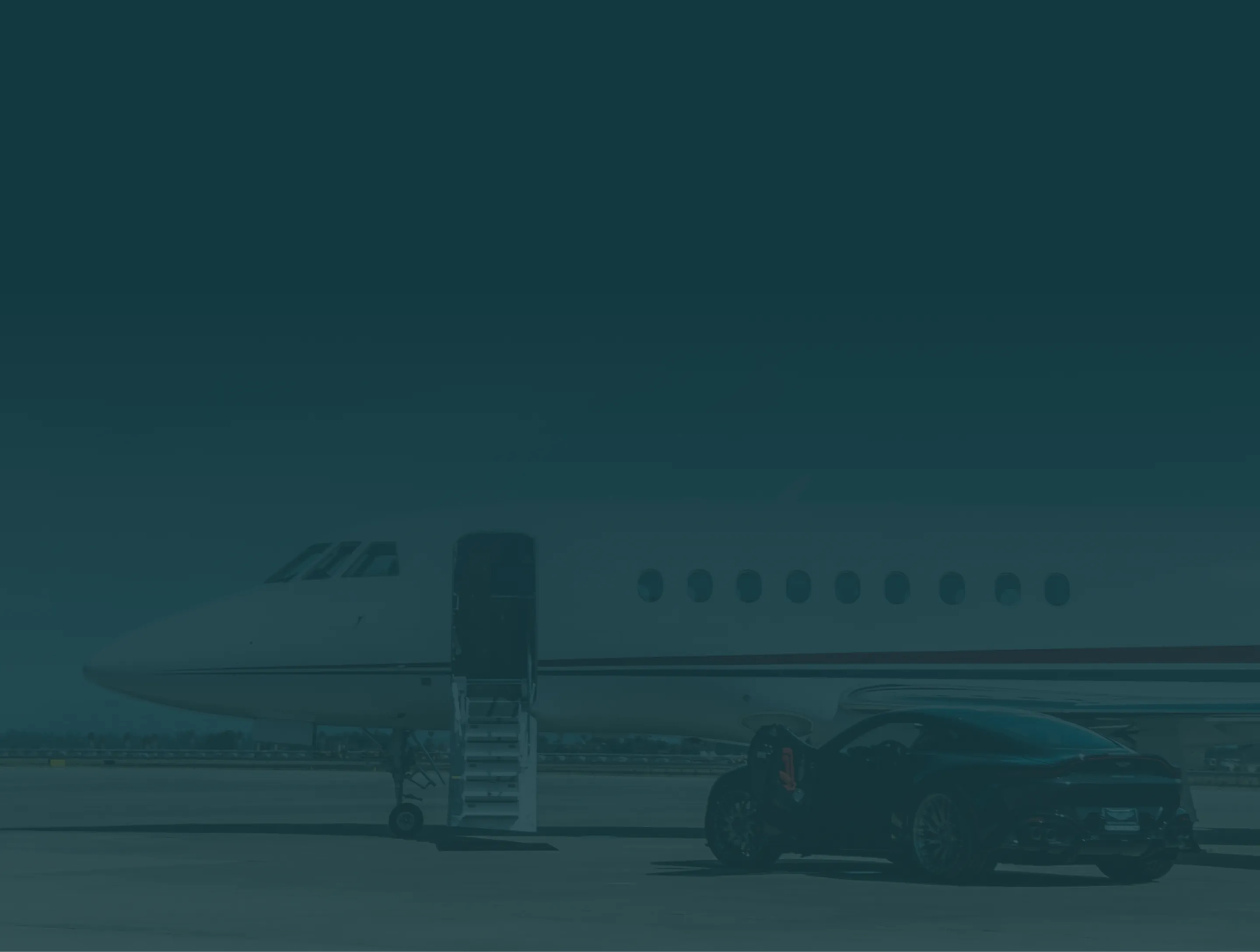 Private jet with stairs extended and black luxury sports car parked nearby on tarmac.