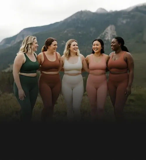 A group of fit women outside in a nature setting.