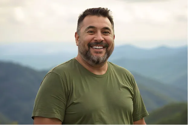 A man looking into the distance with his hands on his hips