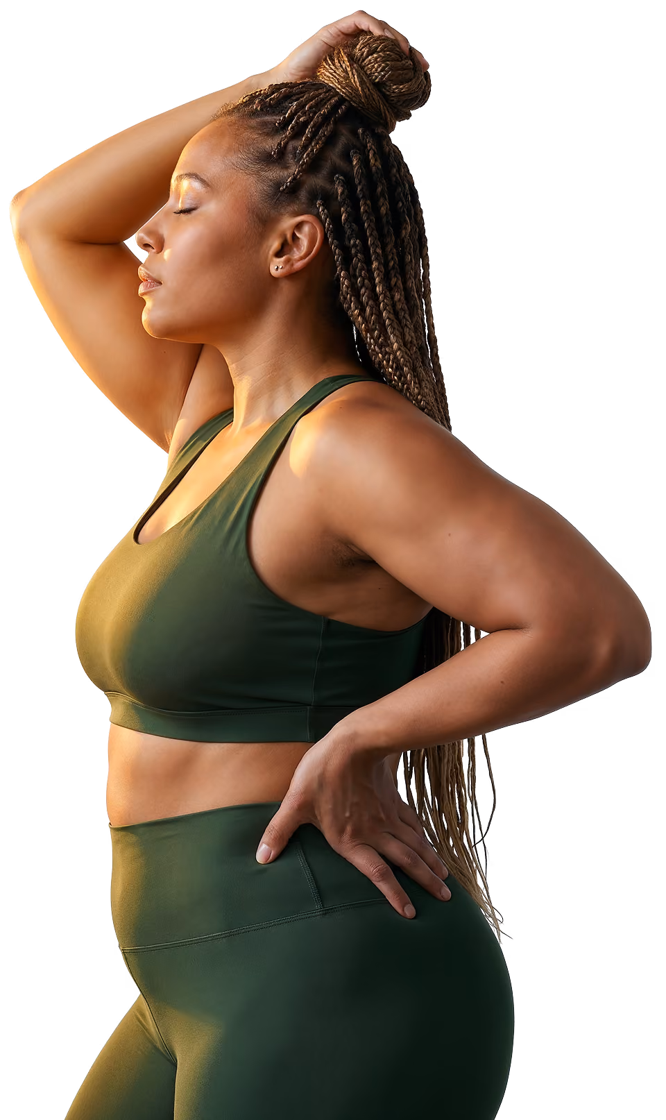 Sunlit woman in green athletic wear with braided hair posing with eyes closed and one hand on head and hip.