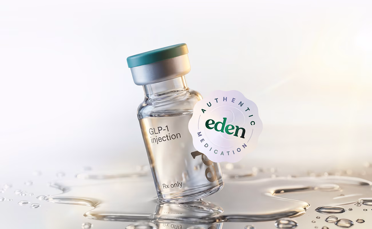 Glass vial labeled GLP-1 injection with Eden authentic medication seal on sunlit reflective surface.