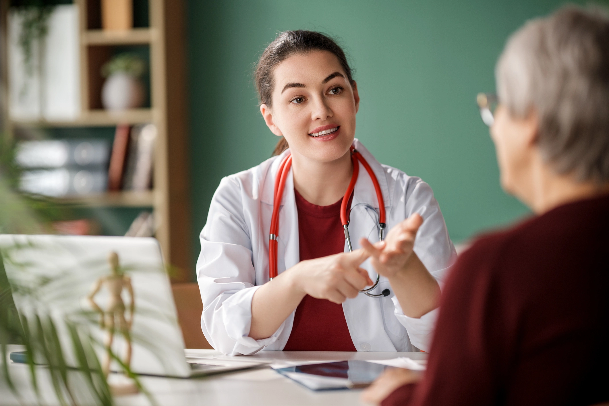 Woman speaking with a healthcare provider for an article about women's hormone health, symptoms, testing, and treatment options.