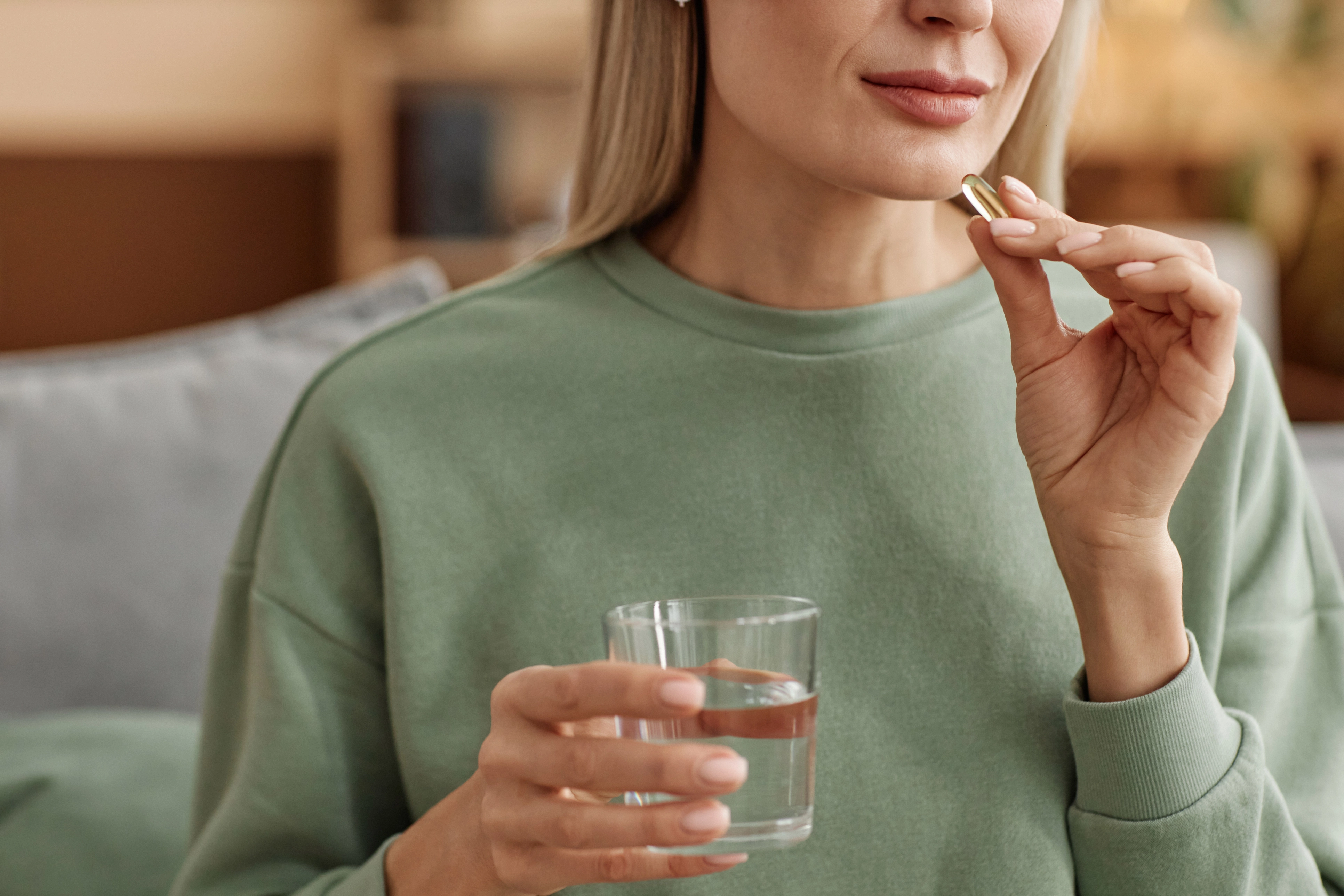 Oral medication and water for an article about Foundayo side effects and what to discuss with a provider.