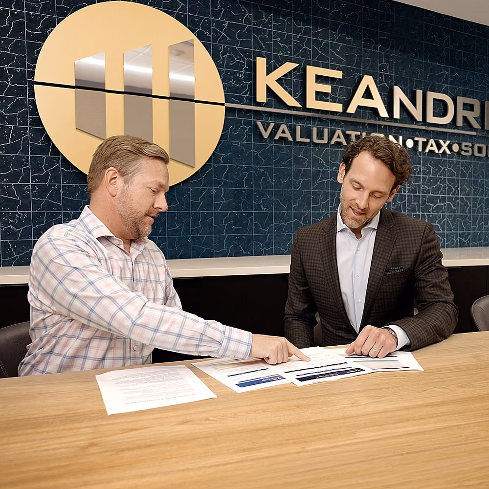 Two professionals reviewing documents at the KE Andrews office