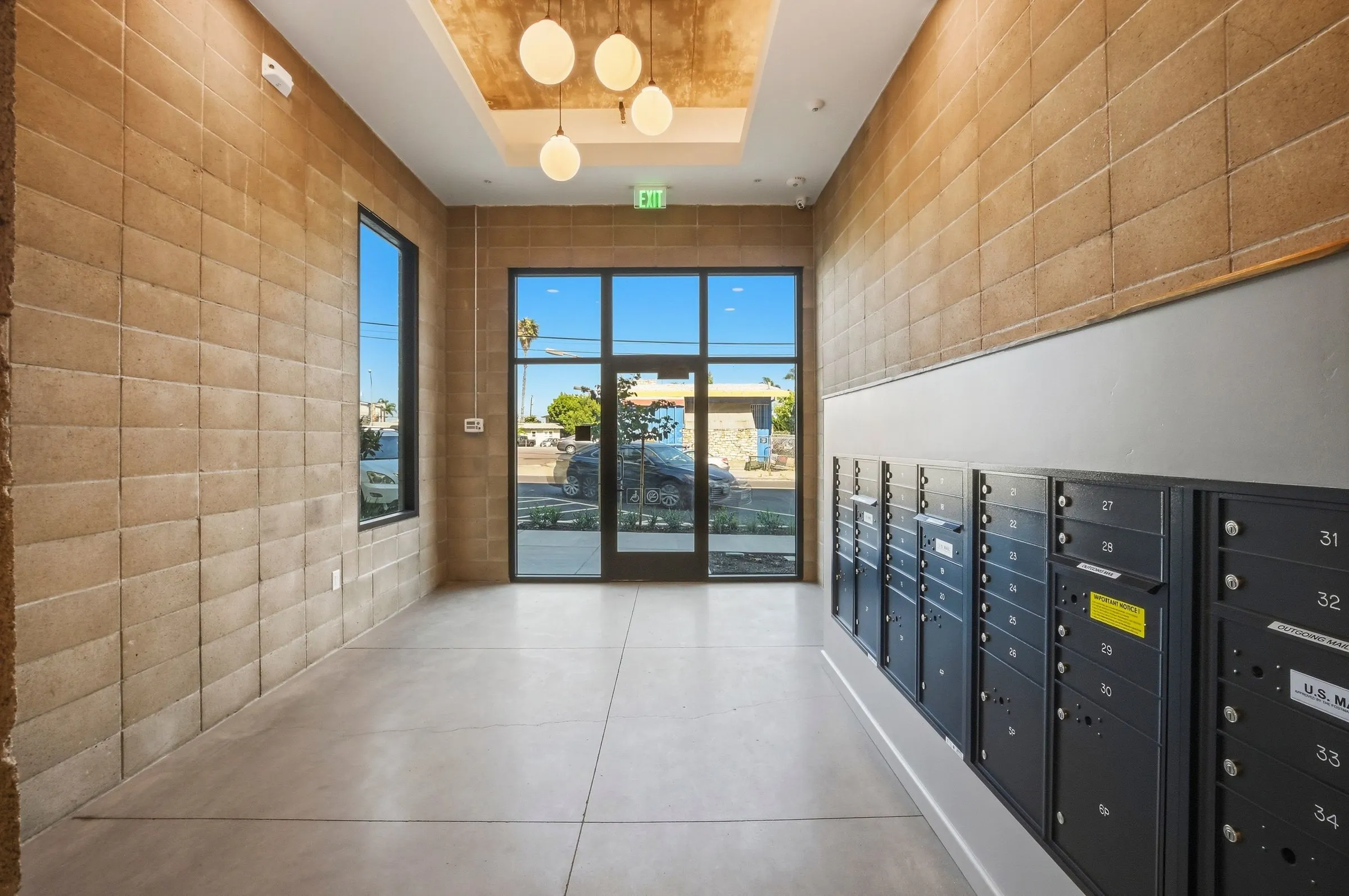 A rooftop patio with people socializing, grilling food, and dining with a city view in the background.