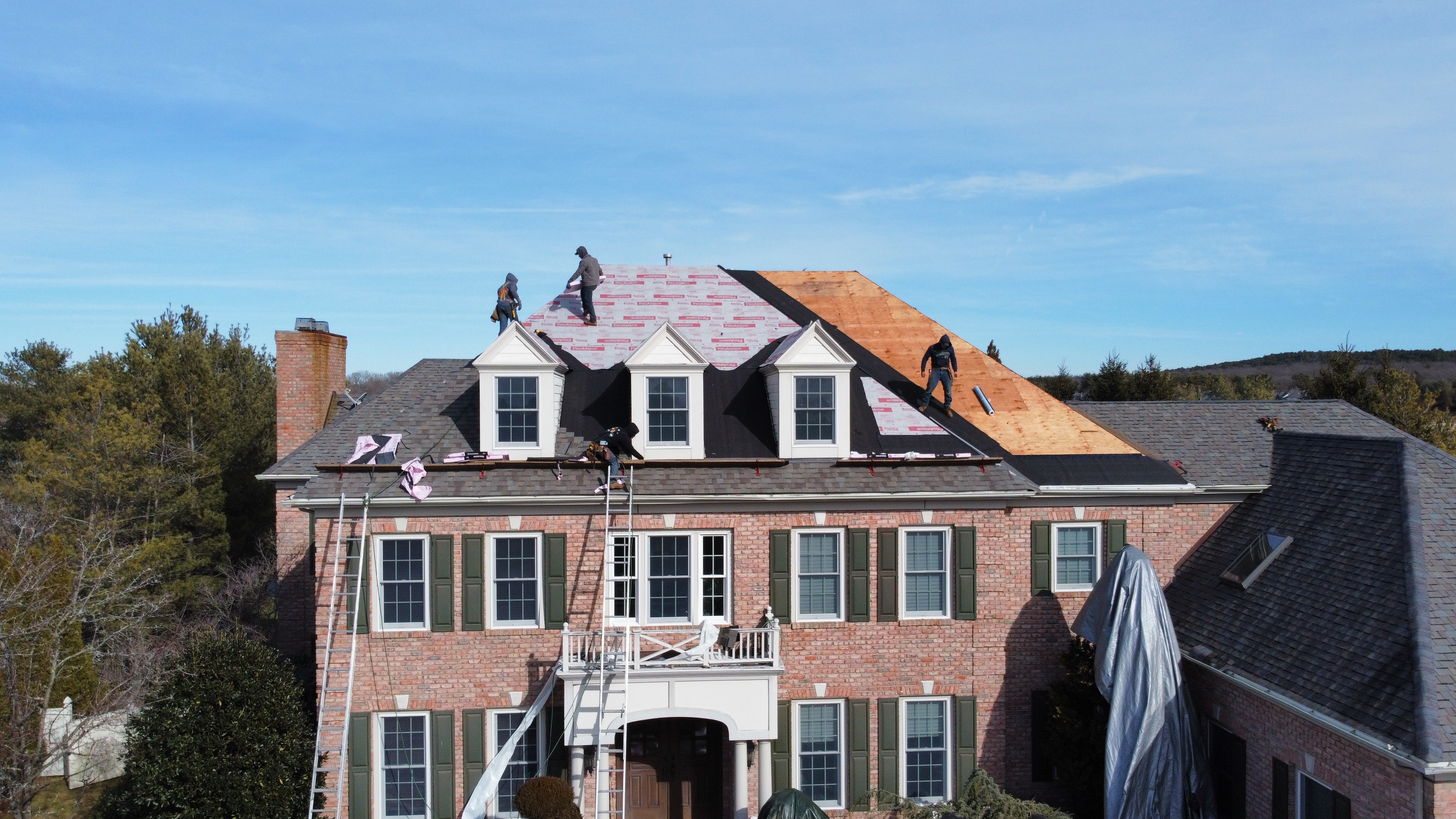 Smart Choice Contracting team working on a roof replacement in Nassau County, NY