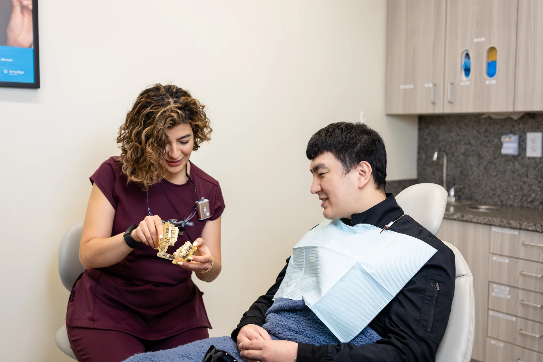 Dentist reviewing a tooth model with a patient during a cosmetic consultation at Seattle's Downtown Dentist