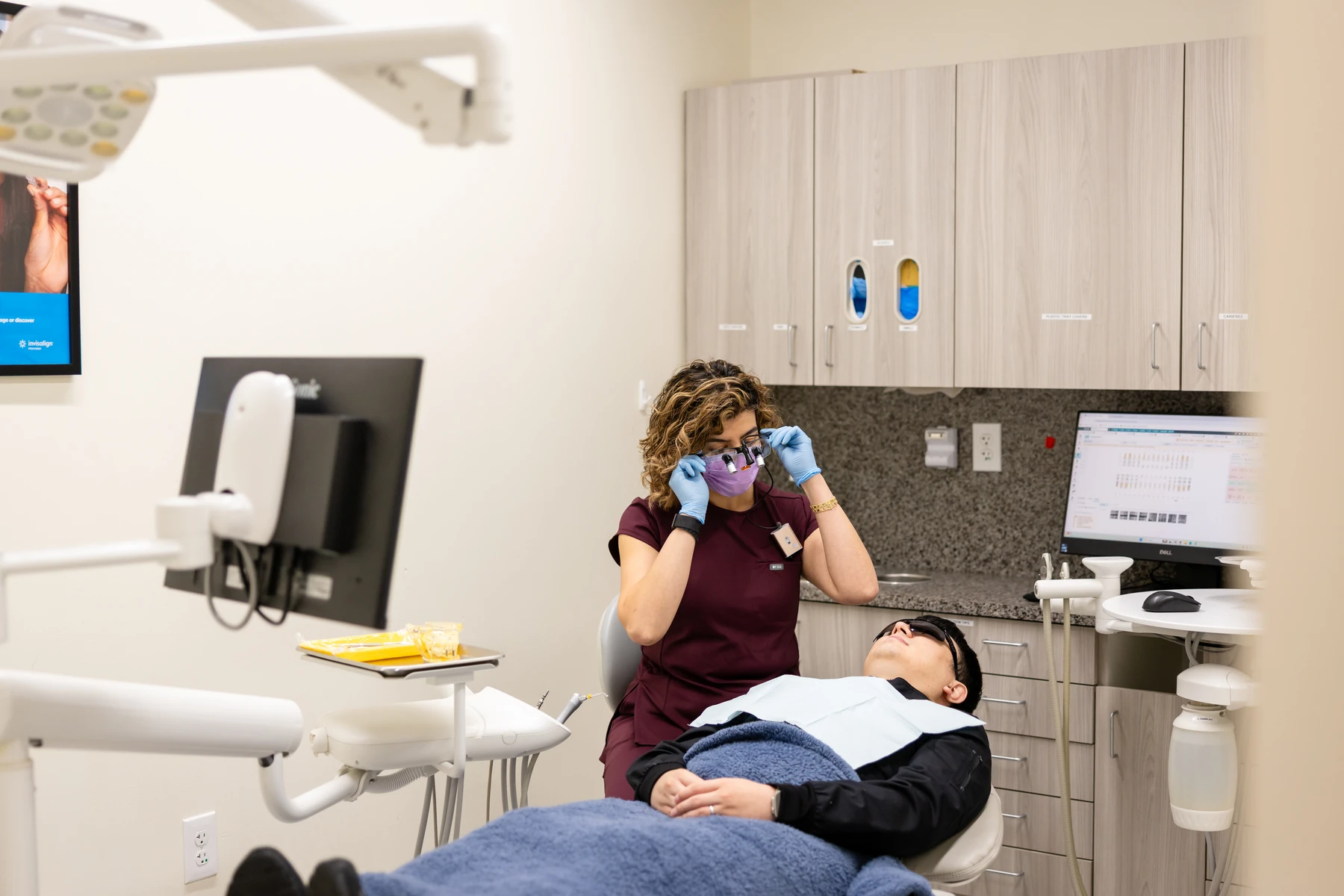 Dental team member preparing to treat a patient in the chair