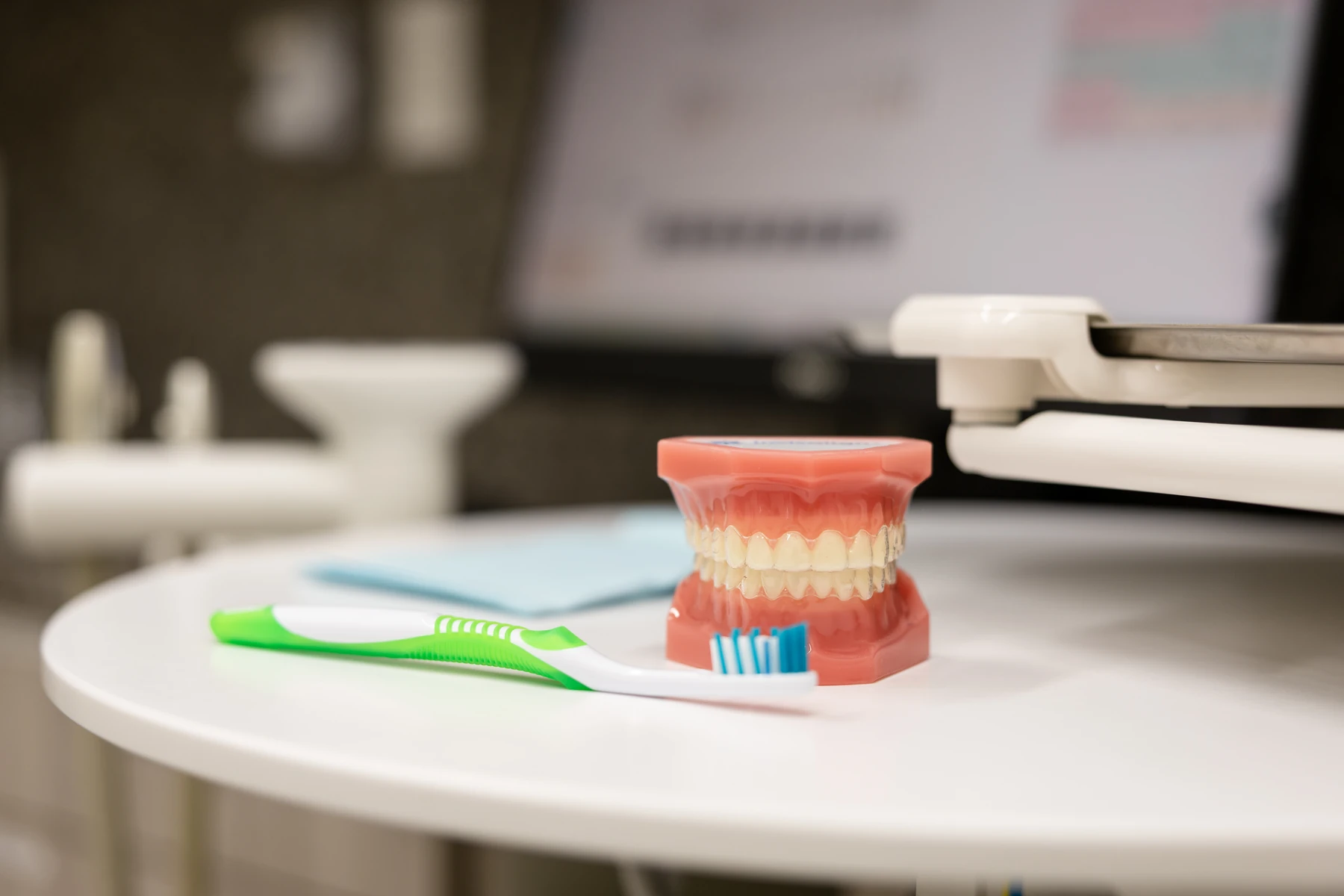 Model of teeth and a toothbrush on a table in the treatment room