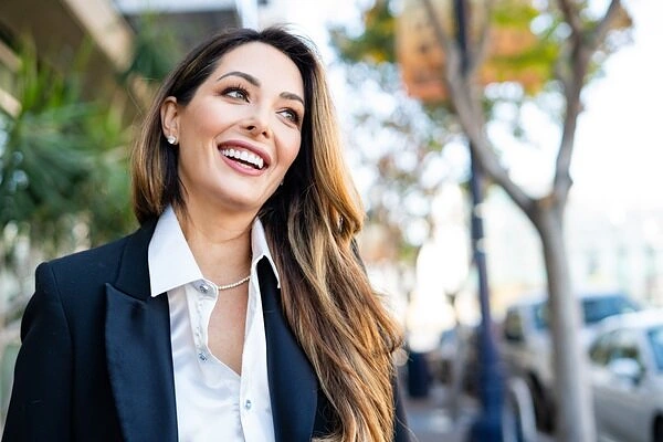 Woman smiling while walking outdoors