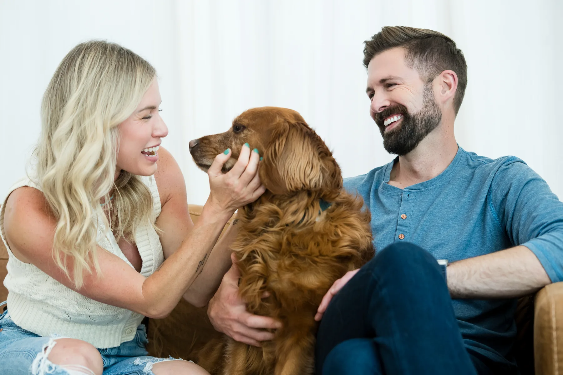 Couple relaxing at home with their dog