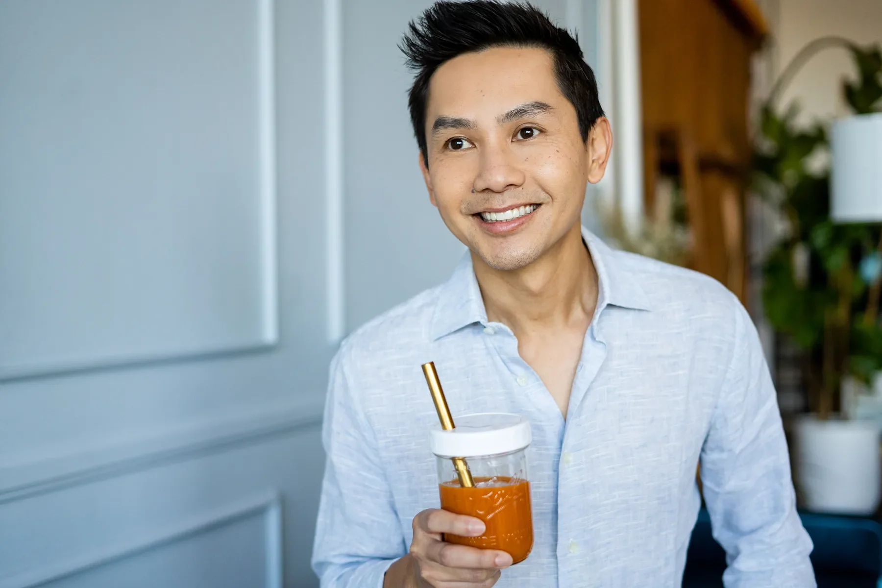 Man holding an iced drink outdoors