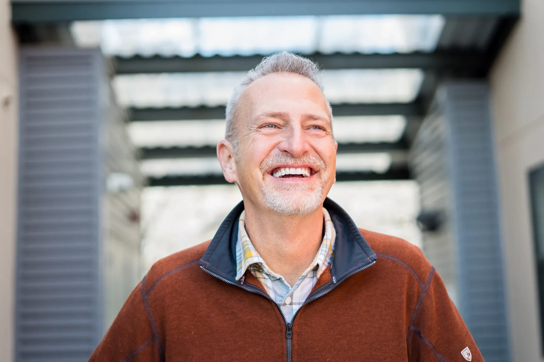 Older man laughing outdoors